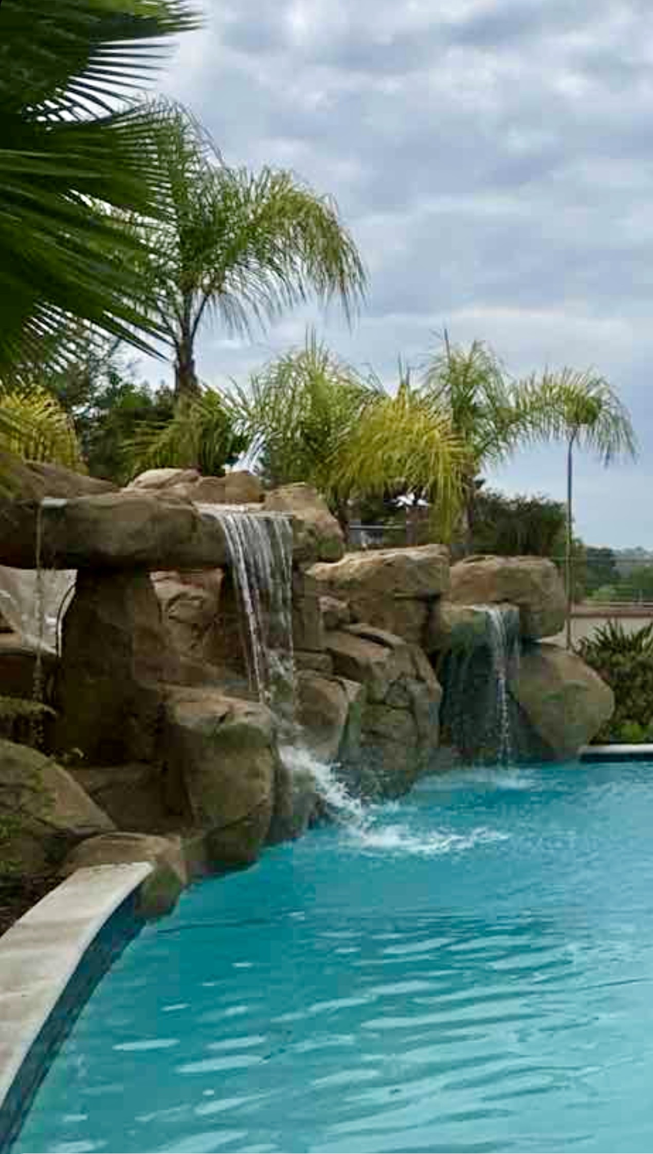 Pool waterfall and aeration features in action, accelerating gas exchange at the water surface.