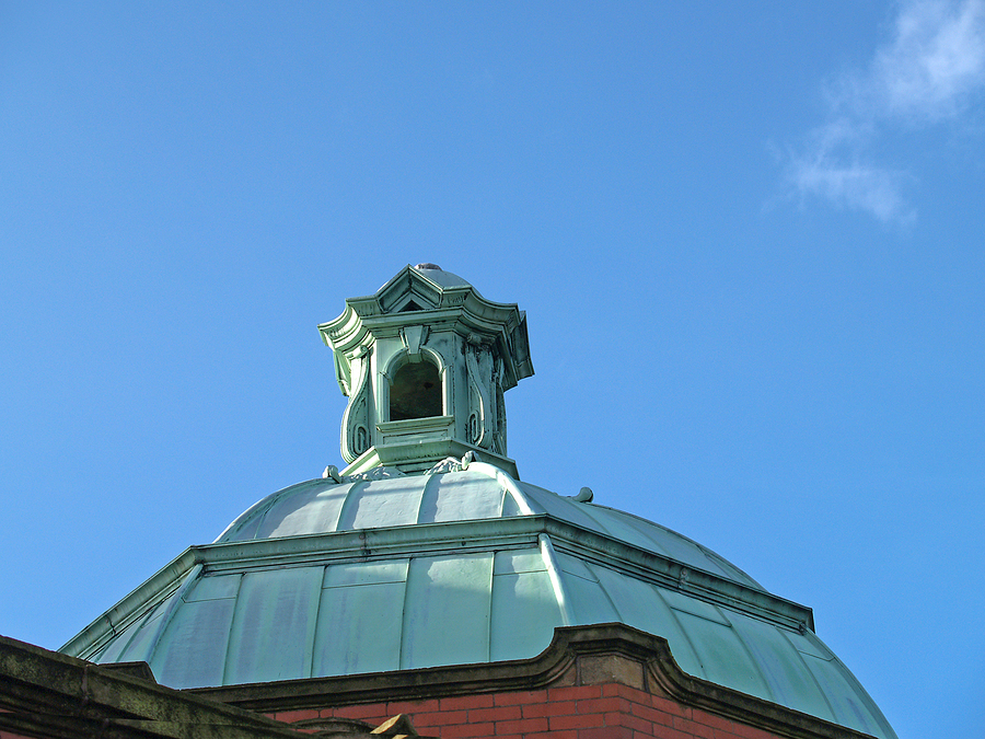 A copper roof showing the green oxidation patina that develops over years of weathering.