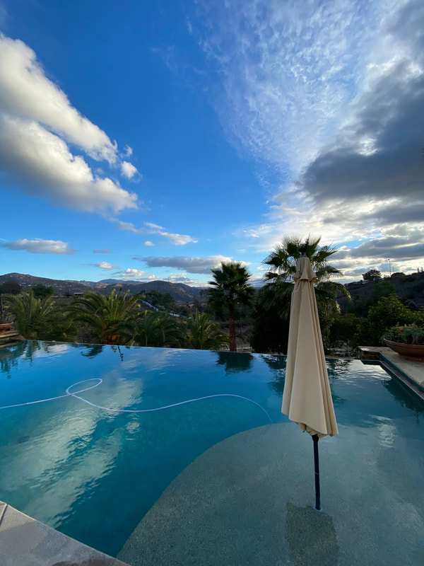 Infinity-edge residential pool overlooking the mountains in San Diego North County, maintained by Safewater Pool Care.