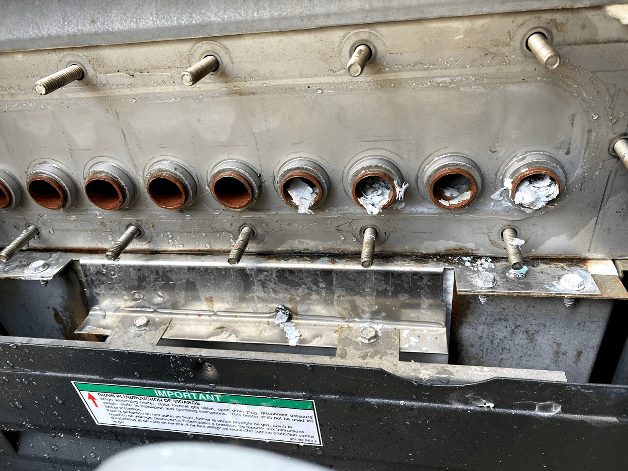 Scale buildup on heater elements caused by supersaturated pool water.