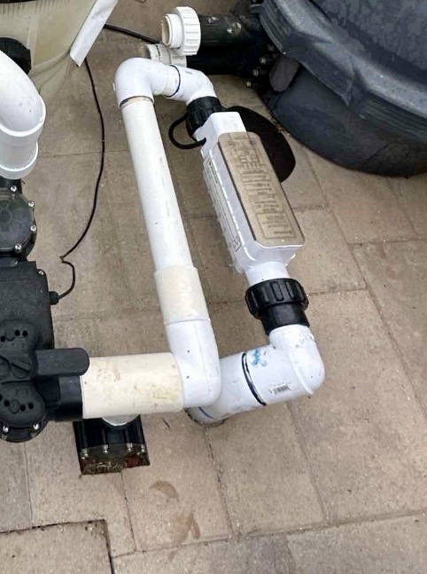 A salt cell plumbed incorrectly: a 90-degree elbow goes straight into the inlet, creating a perfect place for air to pocket on the flow switch.